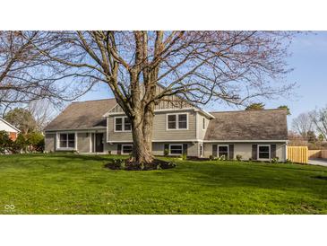 Lovely home exterior with mature trees, offering a blend of brick and siding for classic curb appeal at 220 Pine Dr, Indianapolis, IN 46260
