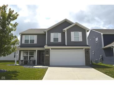 Charming two-story home featuring a manicured lawn, gray siding, white trim, and a two-car garage at 2913 W Broderie Ln, Monrovia, IN 46157
