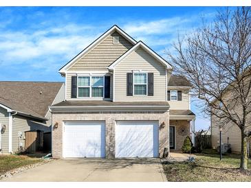 Charming two-story home with a two-car garage and manicured lawn, perfect for a growing Gathering at 3423 Shadow Bend Dr, Columbus, IN 47201