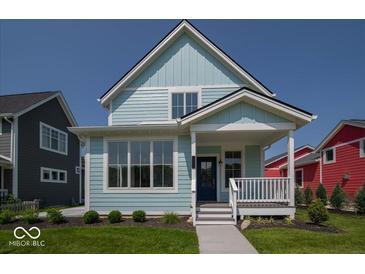 Charming two-story home with light blue siding, a cozy front porch, and well-maintained landscaping at 5421 Upper Garden Way, Zionsville, IN 46077