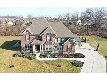 Beautiful two-story brick home with manicured landscaping and a long driveway at 5683 Oakmont Blvd, Bargersville, IN 46106
