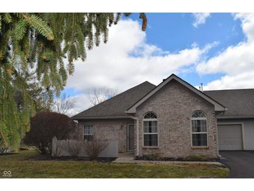 Charming brick home featuring a well-maintained lawn and an attached garage at 6725 Bridgefield Way # 1, Indianapolis, IN 46254
