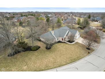 Stunning aerial view of a brick home with a well-manicured lawn and mature trees in a serene neighborhood at 7472 Windridge Way, Brownsburg, IN 46112
