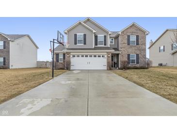 Charming two-story home with a two-car garage, a basketball hoop, and a well-manicured lawn at 8193 Cagles Mill Trce, Avon, IN 46123