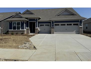 Charming single-story home features a two-car garage, blue siding, and stone accents at 9423 Abner St, McCordsville, IN 46055