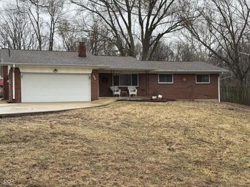 Charming single-story brick home with a well-maintained lawn and attached garage, perfect for comfortable living at 326 W State Road 42, Mooresville, IN 46158