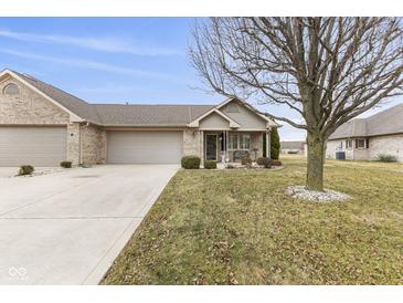 Well-manicured lawn featuring a brick home and trimmed landscaping at 6103 Lazy Ln, Indianapolis, IN 46259