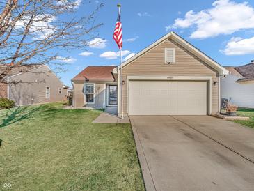 Charming home featuring a well-maintained lawn, two-car garage and American flag at 6905 Percy Dr, Indianapolis, IN 46113