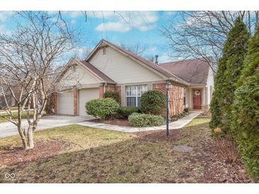Charming single-story home with well-maintained lawn, brick accents, and attached two-car garage at 9694 River Oak E Ln, Fishers, IN 46038