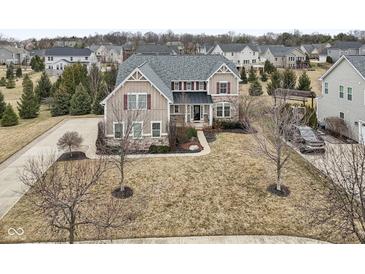 Expansive aerial view of a stately home showcasing its architectural details and well-manicured landscaping at 14466 Integrity Ct, Carmel, IN 46033