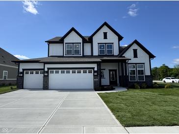 Stunning two-story home with a three car garage and manicured lawn at 15871 Vitalize Run, Fishers, IN 46040