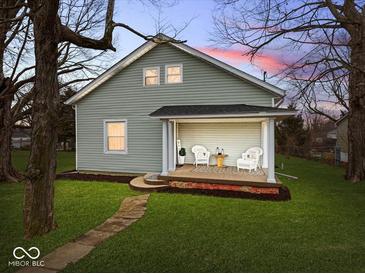 Charming house with a welcoming front porch and well-maintained lawn at 208 S Conger St, , IN 47272