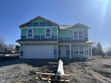 Two-story home under construction with a two-car garage and a covered front porch at 24511 Wallace St, Sheridan, IN 46069