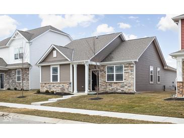 Charming single-Gathering home featuring stone accents, neutral siding, and a well-manicured lawn at 2556 Lamar Dr, Whitestown, IN 46075