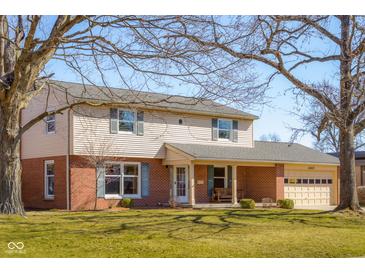 Charming two-story home with brick and siding exterior, two-car garage, and well-maintained front lawn at 2665 Chestnut St, Columbus, IN 47201