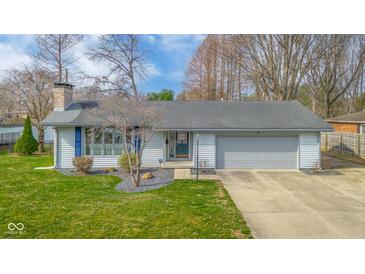 Charming single-story home with attached garage, neat landscaping and cozy front yard at 3232 Beech Dr, Columbus, IN 47203