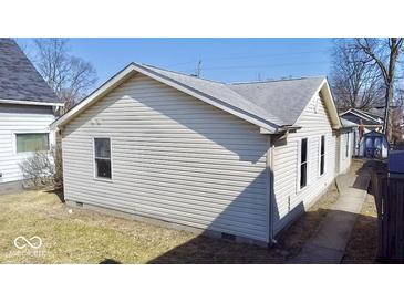 View of home exterior with vinyl siding and gray roof on a sunny day at 4619 Carrollton Ave, Indianapolis, IN 46205