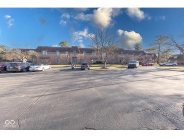 Spacious condo building featuring classic brick facade and ample parking at 5525 Roxbury Ter, Indianapolis, IN 46226