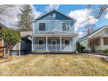 Charming two-story home featuring a welcoming front porch and classic blue siding at 5537 Broadway St, Indianapolis, IN 46220