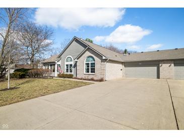 Charming single-story home with a well-maintained lawn and a spacious three-car garage at 5721 Quail Crossing Dr, Indianapolis, IN 46237
