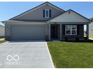 Charming single-story home featuring a neutral-toned exterior and a well-maintained lawn at 6635 Sulgrove Pl, Indianapolis, IN 46221