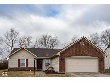 Charming single-story home featuring brick and vinyl siding with an attached two-car garage at 7332 Jackie Ct, Indianapolis, IN 46221