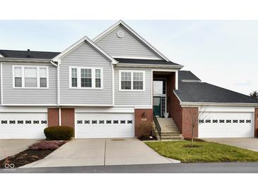 Inviting townhome with attached garages and a well-maintained lawn at 9640 Clover Leaf Ln, Fishers, IN 46038