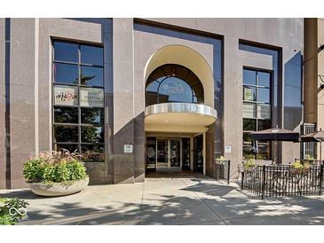 Building entrance with stone facade and an archway, accompanied by adjacent outdoor seating at 110 E Washington St # 1102, Indianapolis, IN 46204
