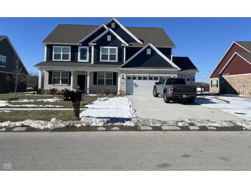 Charming two-story home featuring a two-car garage and a well-maintained front lawn on a clear winter day at 1704 Beach St, Greenwood, IN 46143
