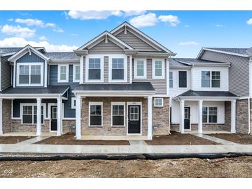 Modern townhomes boast unique color schemes, stone accents and inviting front porches at 19511 Grassy Branch Rd, Westfield, IN 46074