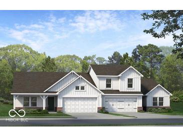 Charming two-story home with white siding, a three-car garage, and a beautifully landscaped front yard at 2150 Aviary Ln, Danville, IN 46122