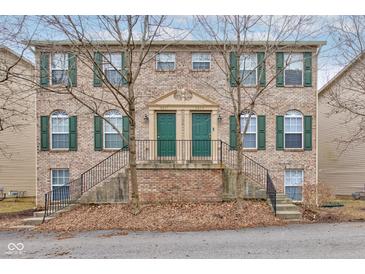 Inviting brick townhome featuring green shutters and doors at 3039 Armory Dr, Indianapolis, IN 46208