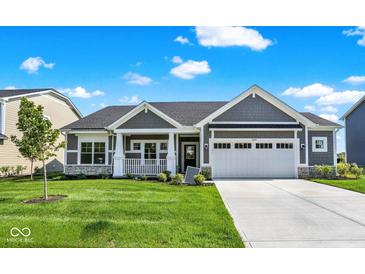 Charming single Gathering home with stone accents, manicured lawn, and a two car garage at 3687 Thomas Jefferson Ct, Westfield, IN 46074