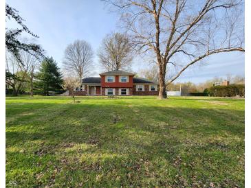 Charming two-story home with brick and siding, situated on a large lot with mature trees at 8143 Filly Ln, Plainfield, IN 46168