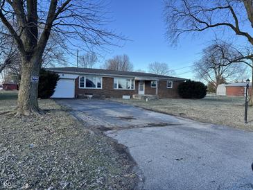 Charming brick home with a spacious driveway and a well-maintained front yard at 9704 Porter Dr, Avon, IN 46123