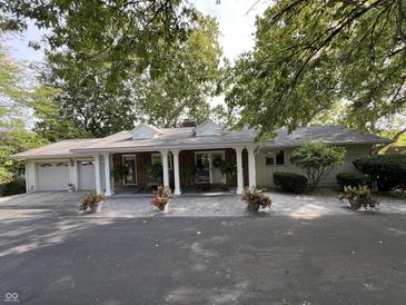 Charming one-story home with a welcoming front porch and well-manicured landscaping at 1020 W Riverview Dr, Anderson, IN 46011