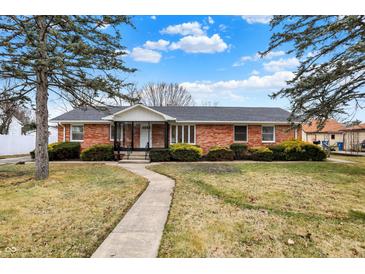 Charming brick ranch home featuring a well-manicured lawn and inviting walkway at 1157 Evans Ave, Noblesville, IN 46060
