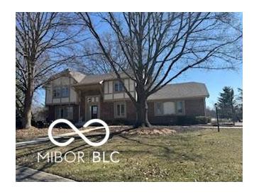 Charming two-story home features a well-maintained lawn and mature trees at 15237 Citation Rd, Carmel, IN 46032
