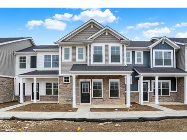 New two-story townhomes with brick and siding exteriors under a blue sky at 19499 Grassy Branch Rd, Westfield, IN 46074