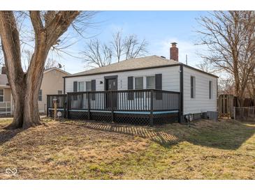 Charming home with a spacious front deck area, mature tree, and classic curb appeal at 317 Albany St, Indianapolis, IN 46225