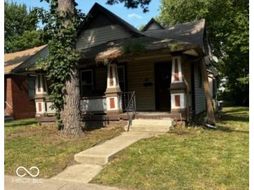 Charming home with a traditional design and inviting front porch at 327 N Bradley Ave, Indianapolis, IN 46201