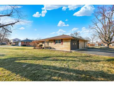 Charming single-story home with stone facade, mature trees, and a well-manicured lawn at 358 Webb Dr, Indianapolis, IN 46227