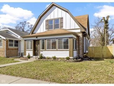 Charming two-story home featuring unique architectural details and a well-manicured front yard at 360 S Spencer Ave, Indianapolis, IN 46219