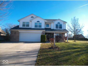Charming two-story home with brick accents, a two-car garage, and a well-manicured front lawn at 777 West St, Whiteland, IN 46184