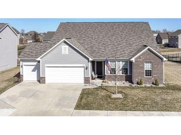 Charming home featuring vinyl siding, brick accents, and a well-manicured front yard, creating a welcoming curb appeal at 936 Plunkett Ave, Westfield, IN 46074