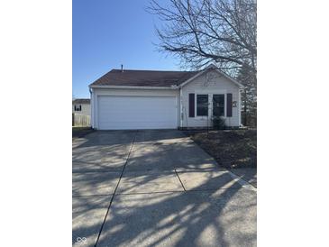 Charming home featuring a two-car garage, well-maintained lawn, and inviting curb appeal at 10793 Walnut Grove Bnd, Camby, IN 46113