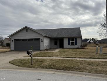 Charming single-story home with a gray exterior and attached garage at 2418 Shorewood Dr, Lebanon, IN 46052