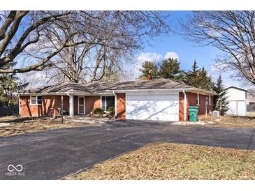 Charming red brick ranch-style home with a well-maintained asphalt driveway and attached two-car garage at 244 Corottoman Ct, Avon, IN 46123