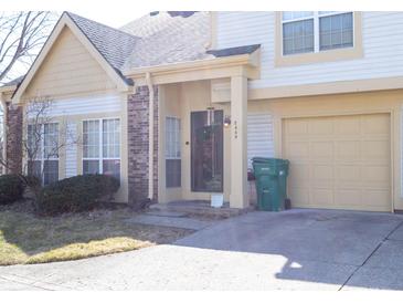 Two-story home featuring an attached garage, tidy lawn, and welcoming covered front entryway at 2449 Chaseway Ne Ct # Blk B, Indianapolis, IN 46268