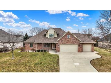 Charming brick home with a well-manicured lawn and a three-car garage at 3801 S Cedar Creek Ln, New Palestine, IN 46163